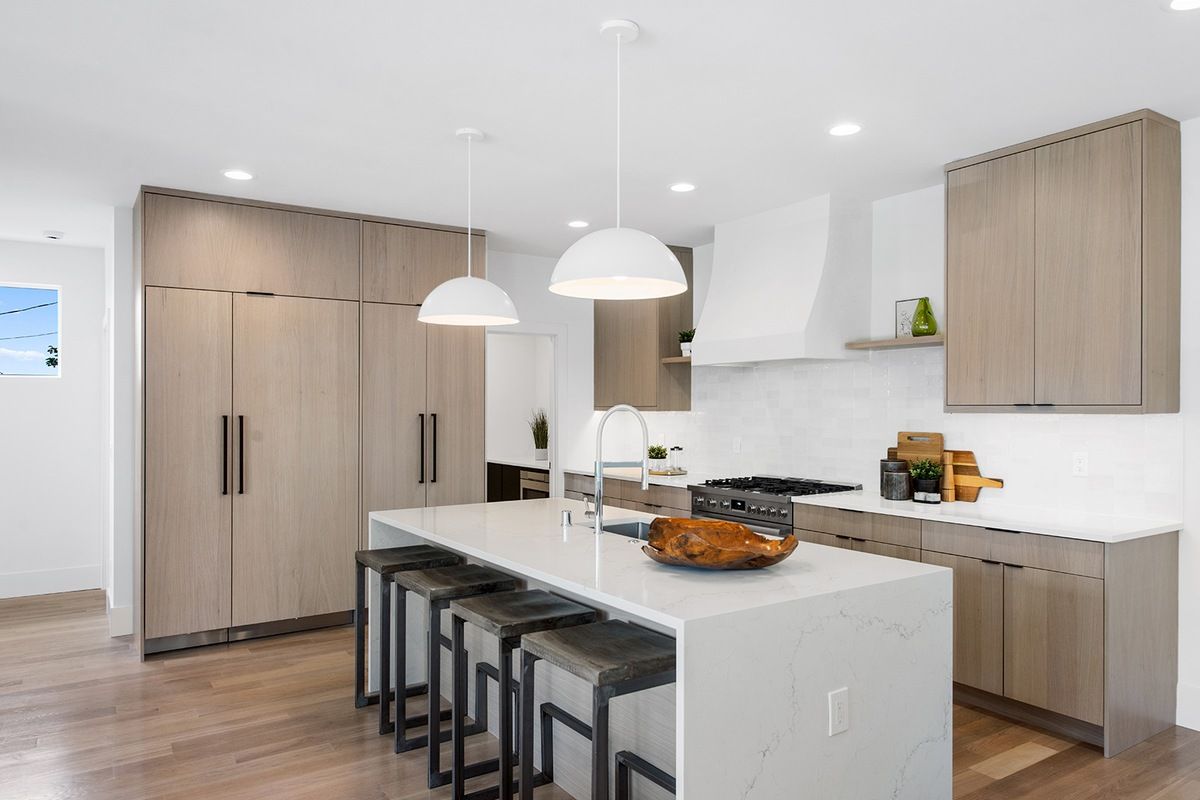 Kitchen with island and Venetian plaster hood