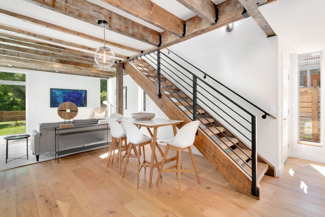 Living and dining room under reclaimed timber beams