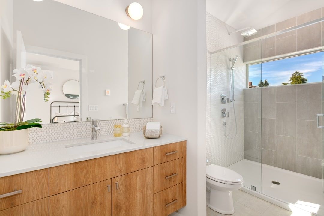 Bathroom with wood vanity and walk-in shower