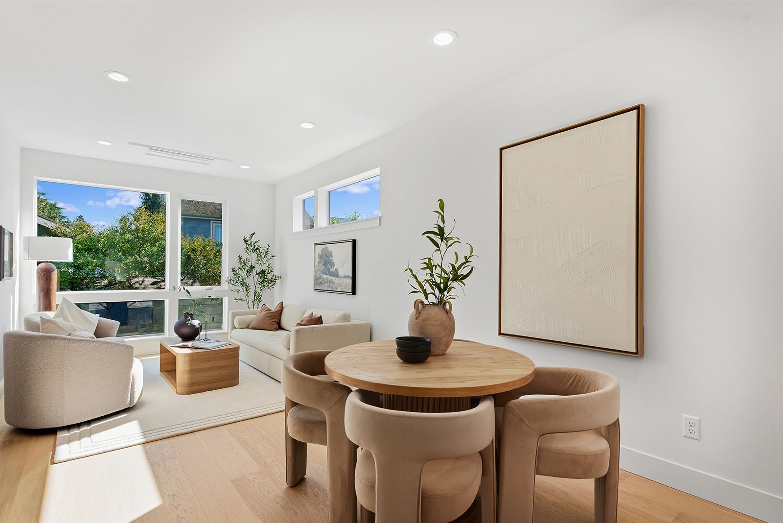Living and dining room with oak floors and large windows